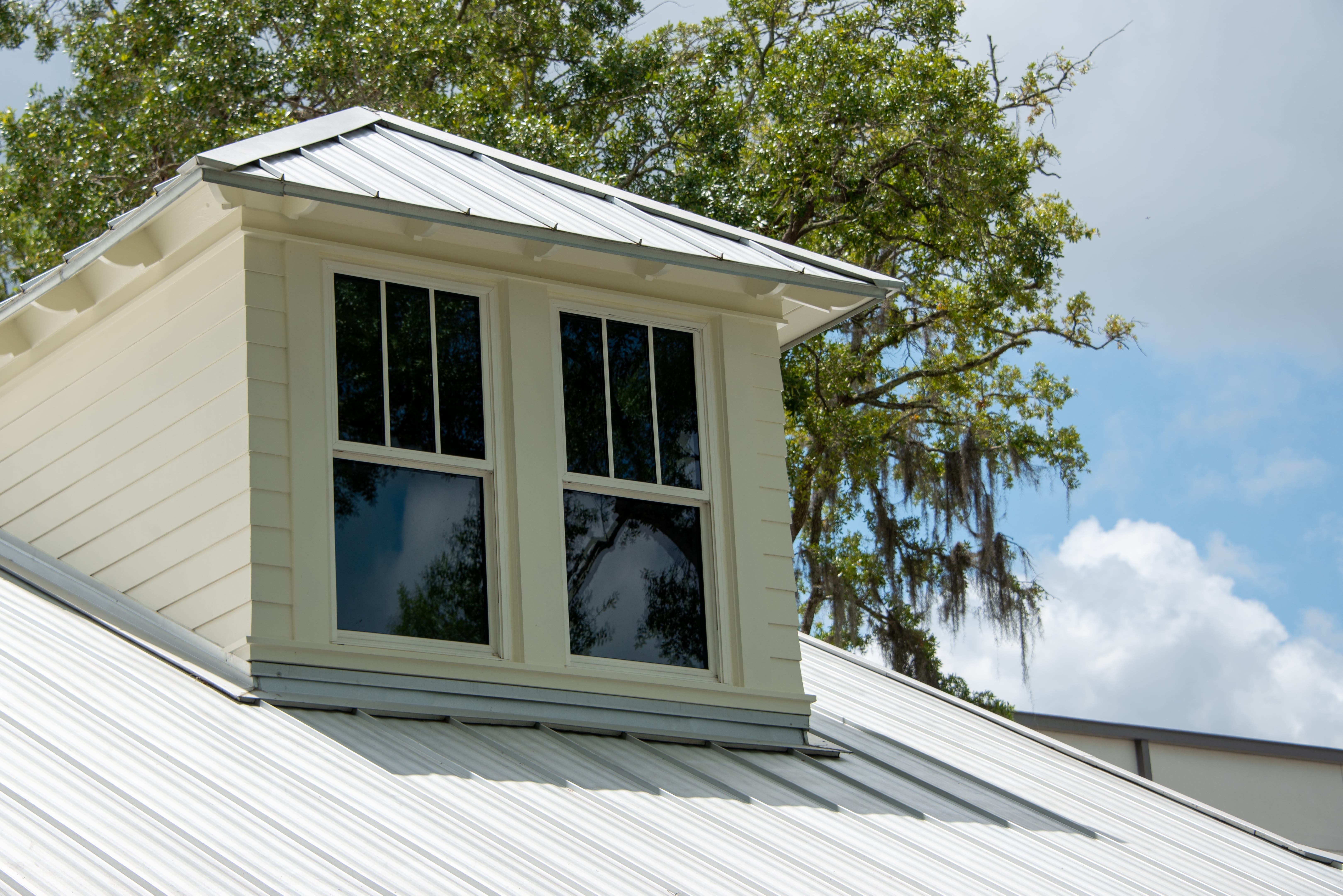 a,dormer,with,multiple,double,hung,windows,,a,grey,metal