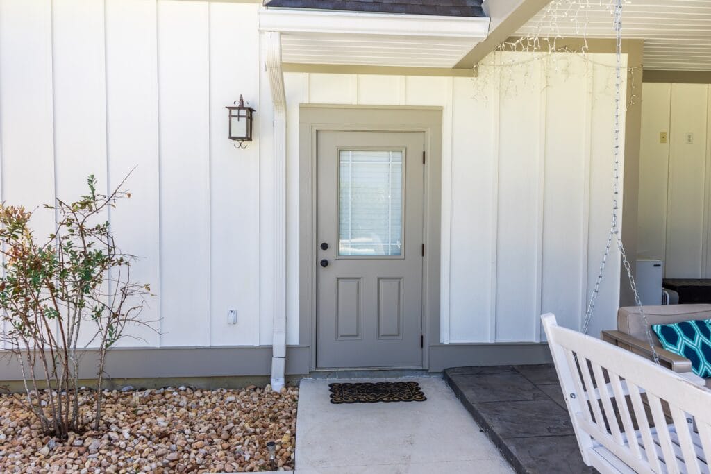 a,taupe,rear,side,back,door,of,a,new,construction